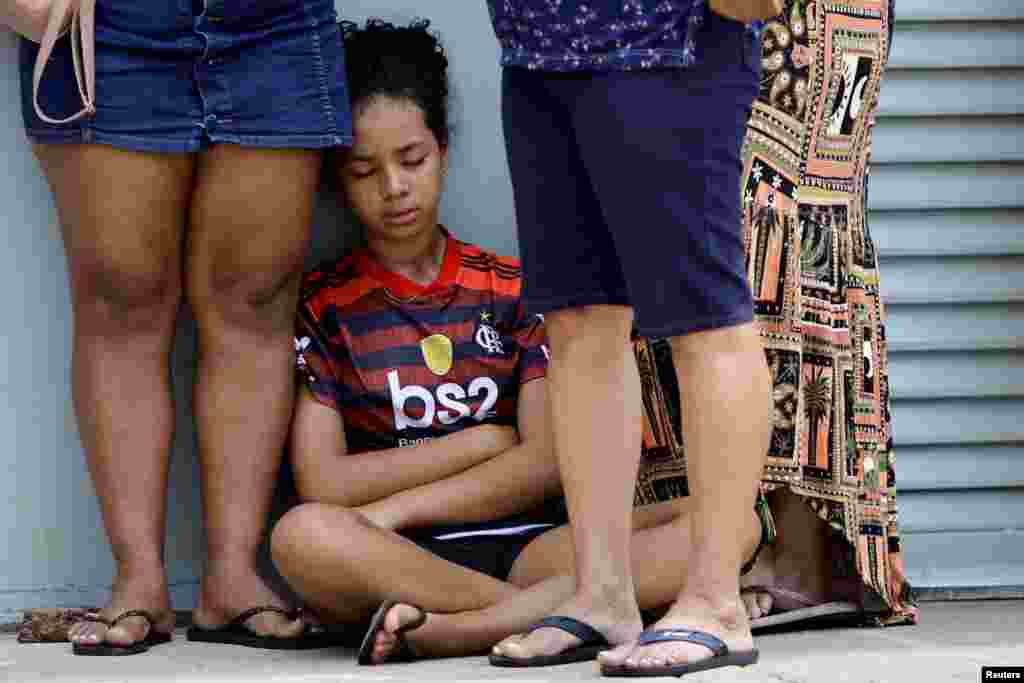 Patients wait in line to receive medical attention in a makeshift tent to treat suspected dengue cases, in the administrative region of Ceilandia, on the outskirts of Brasilia, Brazil, Feb. 5, 2024.