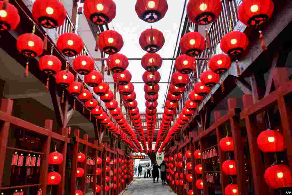 People walk past lanterns ahead of the Lunar New Year in Qingdao, in China's eastern Shandong province.