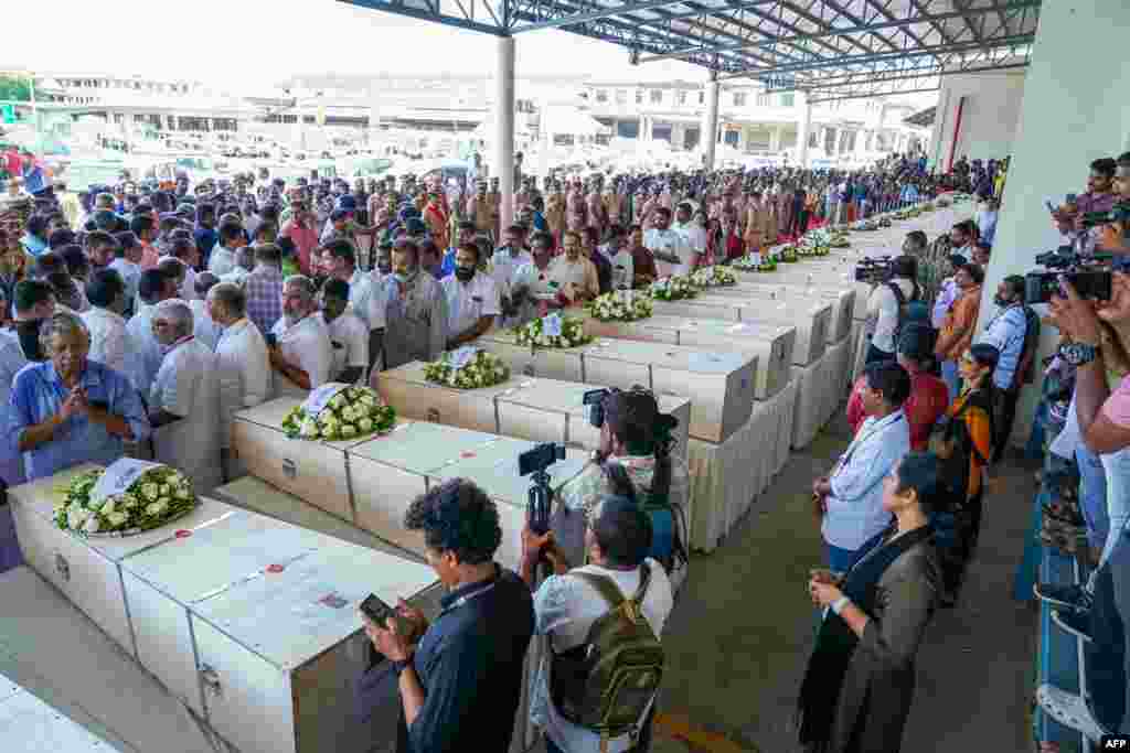 Relatives mourn near the deceased after the coffins arrive on an Indian Air Force plane from Kuwait at the Cochin International Airport in Kochi, India. Grieving families kept a solemn vigil in the terminal of an Indian airport as the bodies of dozens of migrant workers killed in a Kuwait building fire returned home. 