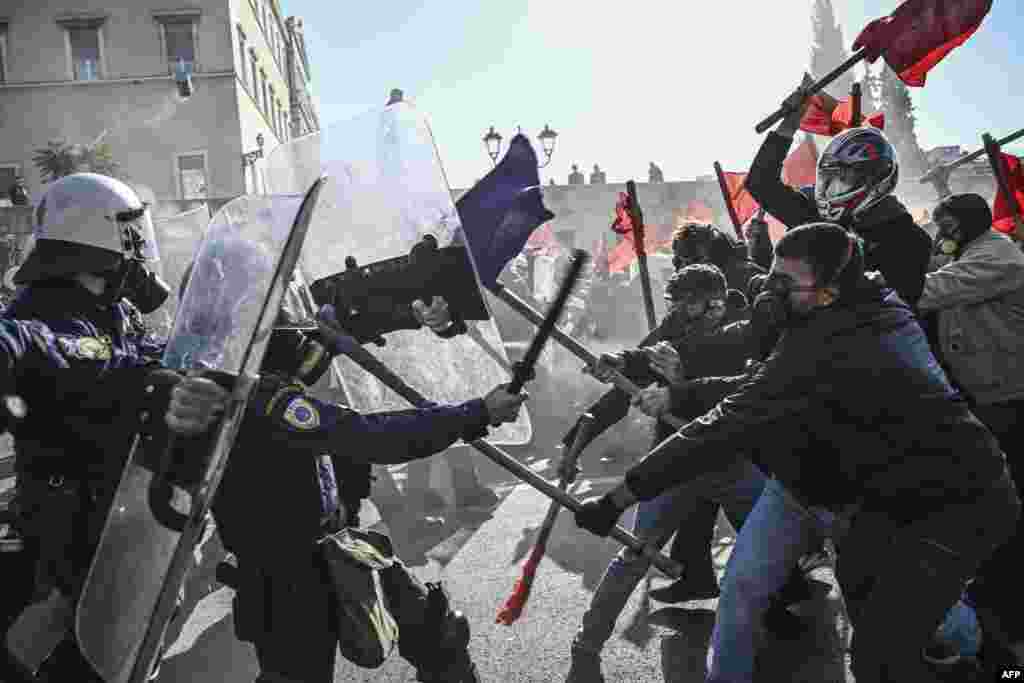 Students clash with riot police in front of the Greek Parliament during a demonstration against the government's plans for private universities, in Athens.