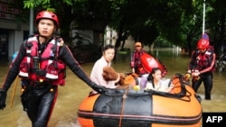 ບັນດານັກກູ້ໄພ ທໍາການຍົກຍ້າຍປະຊາຊົນດ້ວຍເຮືອຢາງ ເມິງບໍລິເວນຖະໜົນທີ່ຖືກນໍ້າຖ້ວມ ລຸນຫຼັງພາຍຸຖະຫຼົ່ມເມືອງກຸຍຫຼິນ ແຂວງກວາງຊີ ທີ່ຕັ້ງຢູ່ພາກຕາເວັນຕົກສຽງໃຕ້ ຂອງ ຈີນ, ວັນທີ 19 ມິຖຸນາ 2024.