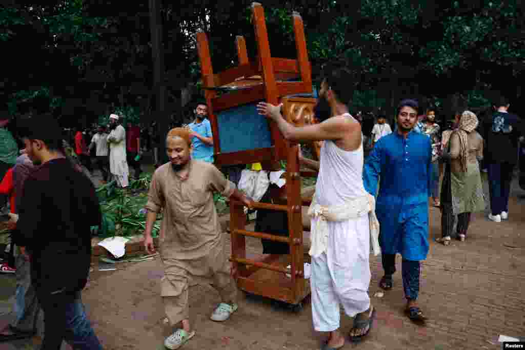 People carry furniture from the Ganabhaban, the Prime Minister's residence, after the resignation of Prime Minister Sheikh Hasina in Dhaka, Aug. 5, 2024.