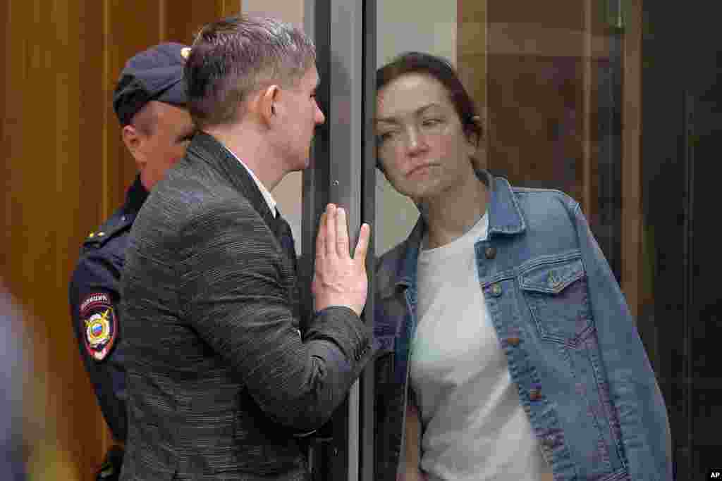 Alsu Kurmasheva, an editor for the U.S. government-funded Radio Free Europe/Radio Liberty's Tatar-Bashkir service, listens to her lawyer during a court hearing in Kazan, Russia.