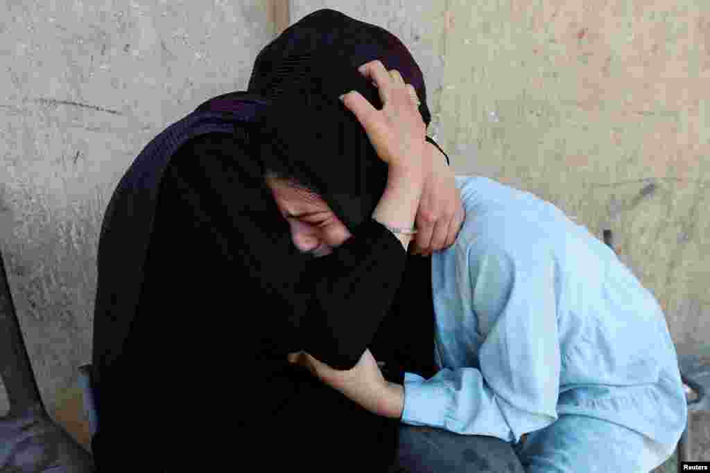 Palestinian women react after an Israeli airstrike on a U.N. school sheltering displaced people in Nusairat in central Gaza Strip.