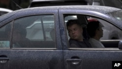 A passenger looks out the window of a car dusted with volcanic ash spewed from the Popocatepetl volcano, in Atlixco, Mexico, May 24, 2023.