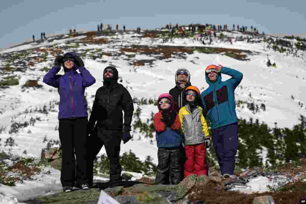 Skiers and hikers watch the total solar eclipse from the Appalachian Trail at the summit of Saddleback Mountain, April 8, 2024, near Rangeley, Maine.