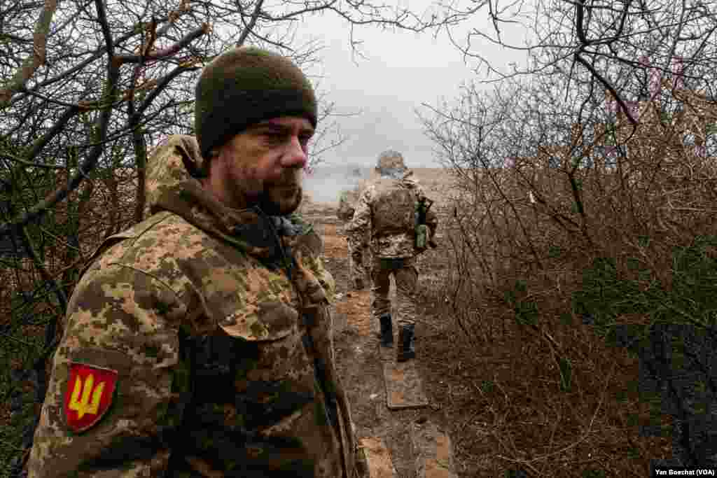 A soldier takes guard in an artillery position near Kupiansk, a city that was occupied by Russian forces and retaken by Ukrainians by the end of 2022, March 6, 2024.