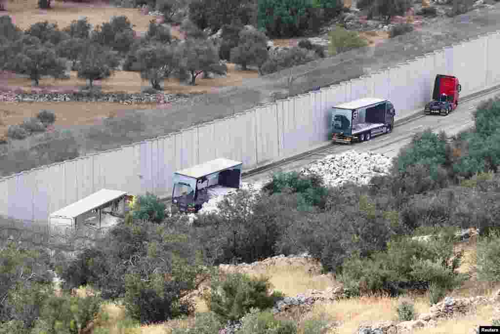 A view of trucks carrying aid to Gaza that were stopped after they were damaged by Israeli settlers near a checkpoint near Hebron in the Israeli-occupied West Bank.