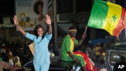 Presidential candidate Anta Babacar Ngom greets supporters during her electoral campaign caravan in Dakar, Senegal, Monday, March 11, 2024. (AP Photo/Sylvain Cherkaoui)