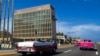 FILE - Tourists in classic cars pass the U.S. Embassy in Havana, Cuba, Oct. 3, 2017. U.S. intelligence agencies cannot link a foreign adversary to any of the incidents associated with “Havana Syndrome” reported by American personnel around the world. 