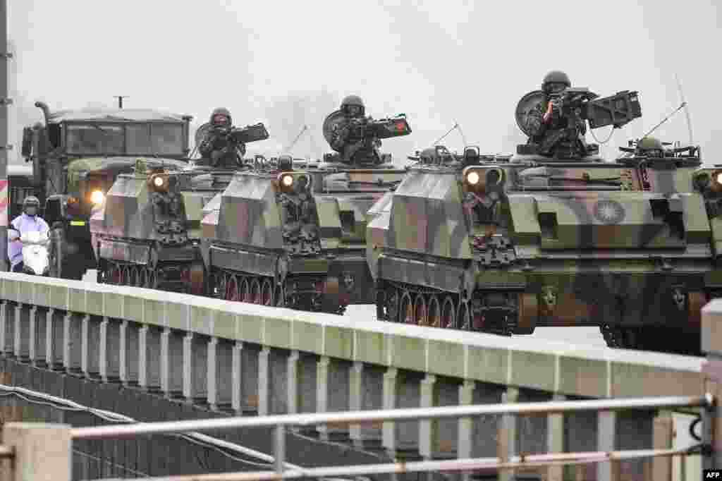 Taiwanese armored vehicles roll down a street in Kinmen. China warned on Friday that Taiwan's leadership was pushing the self-ruled island into "a perilous situation of war and danger" and that it would go "further" if provoked, as Beijing conducted military drills around the territory.
