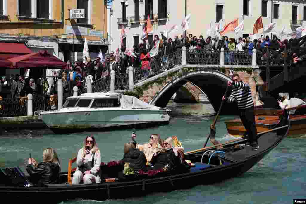 People protest the introduction of the registration and tourist fee to visit the city of Venice for day trippers introduced by Venice municipality in a move to preserve the lagoon city often crammed with tourists in Venice, Italy.