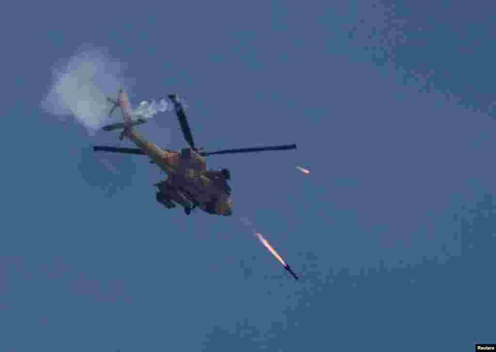 An Israeli military Apache helicopter fires missiles towards Gaza as seen from southern Israel.