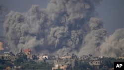 Smoke rises following an Israeli airstrike in the Gaza Strip, as seen from southern Israel, Oct. 23, 2023. 
