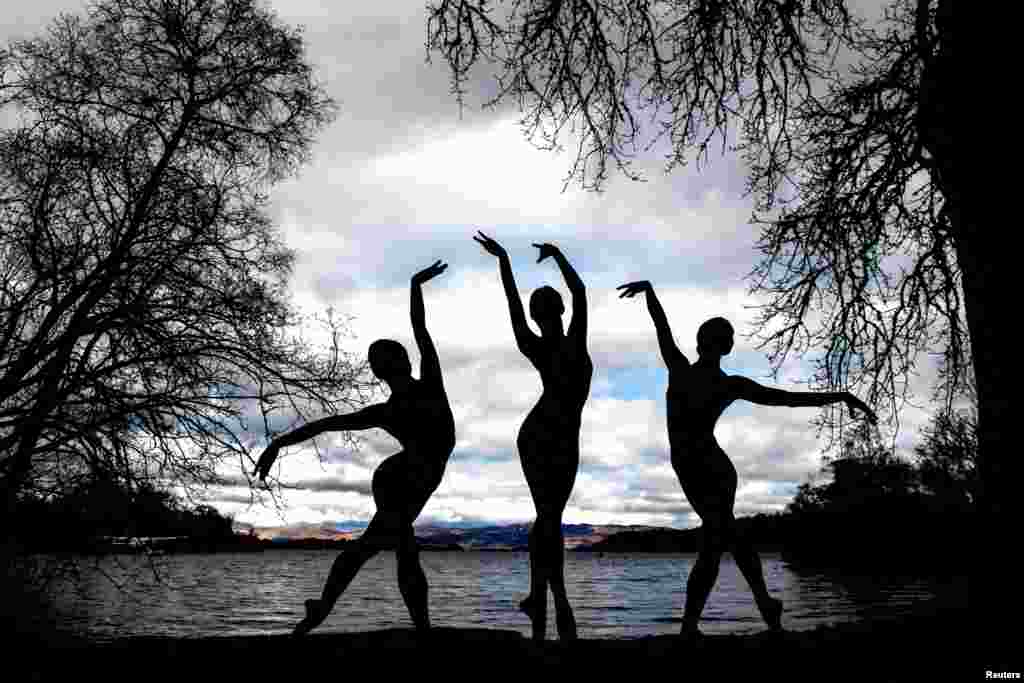 Scottish Ballet dancers Seira Winning Urara Takata and Danila Marzilli dance on the banks of Loch Lomond near Glasgow, in Scotland, Britain, March 26, 2024.