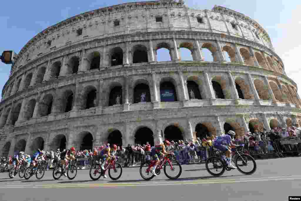 Cyclists ride past the ancient Colosseum during the final stage of the Giro d'Italia cycling race in Rome, Italy.