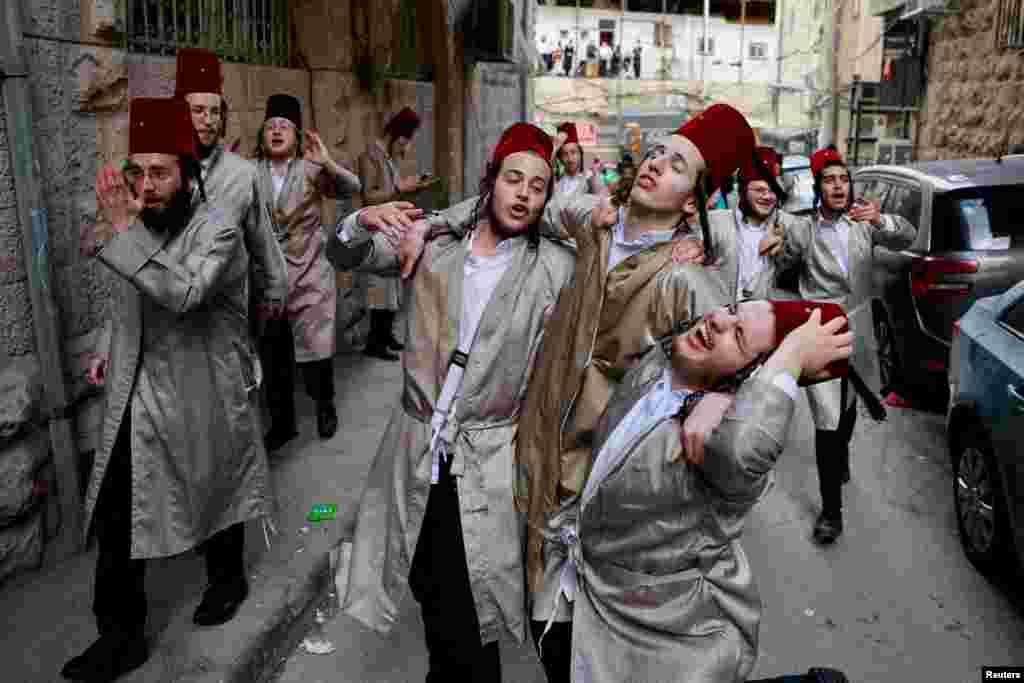 Ultra-Orthodox Jewish men mark the Jewish holiday of Purim, a celebration of the Jews' salvation from genocide in ancient Persia, in the Mea Shearim neighborhood of Jerusalem.