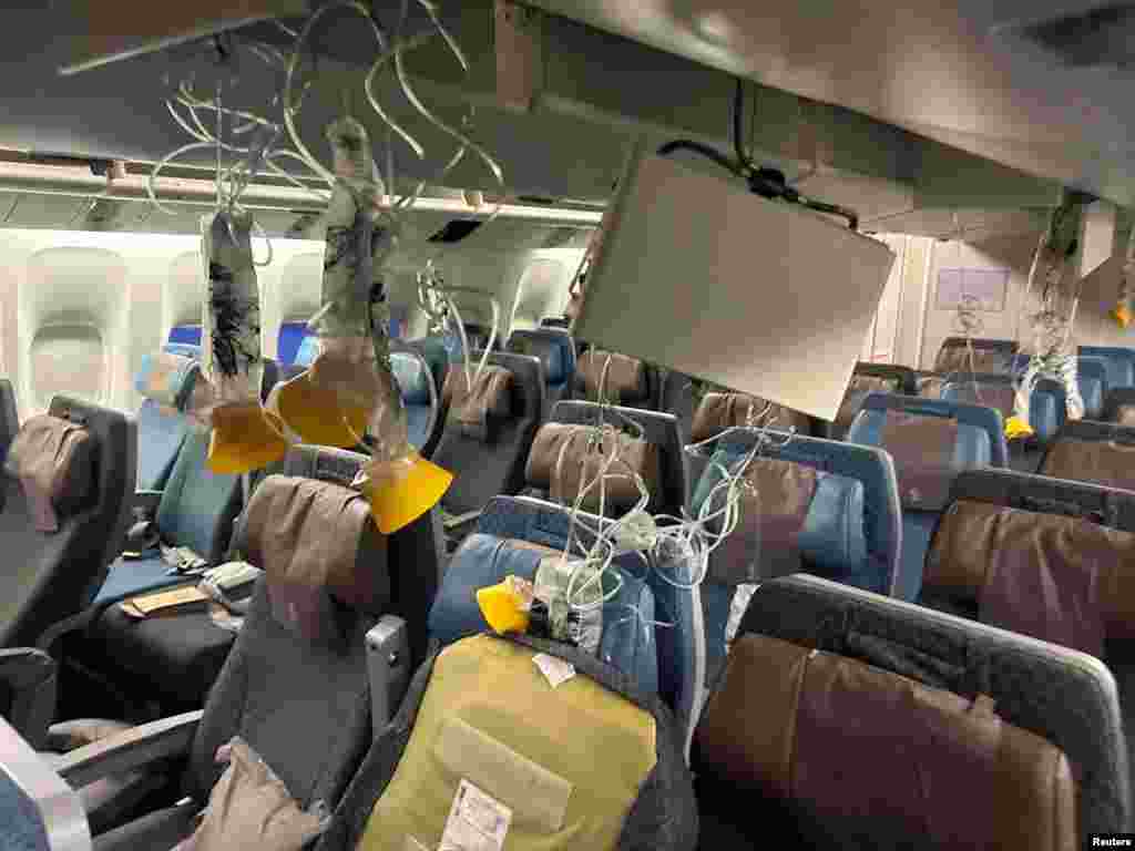 The interior of Singapore Airline flight SQ321 is pictured after an emergency landing at Bangkok's Suvarnabhumi International Airport, Thailand. One passenger died of a suspected heart attack and 30 injured after the flight hit severe turbulence, flinging passengers and crew around the cabin and forcing the plane to land in Bangkok, officials and the airline said.