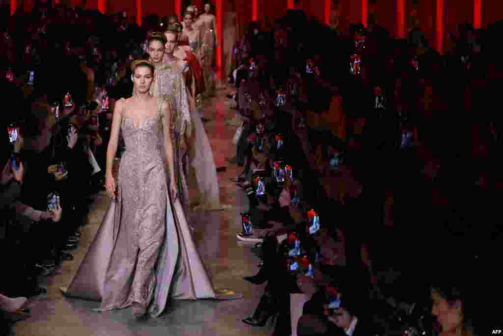 Models present creations by Elie Saab during the Women's Haute-Couture Spring/Summer 2024 Fashion Week in Paris, France.