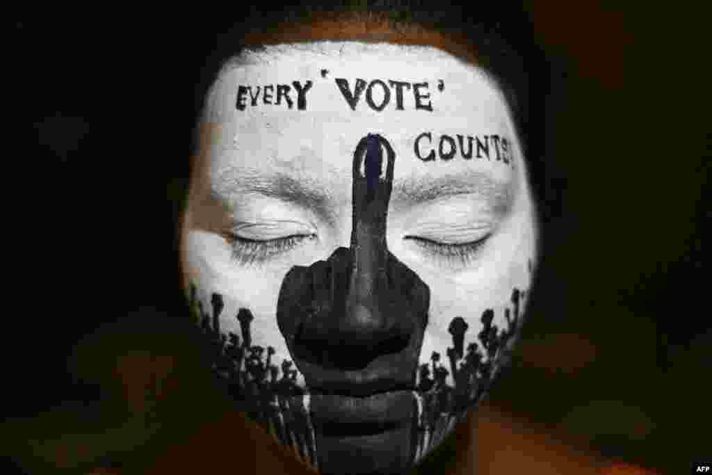 A college student has her face painted to spread awareness for first generation voters during an election campaign ahead of India's upcoming national elections in Chennai.