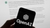 FILE - The OpenAI logo is seen on a mobile phone in front of a computer screen which displays output from ChatGPT, March 21, 2023, in Boston. 