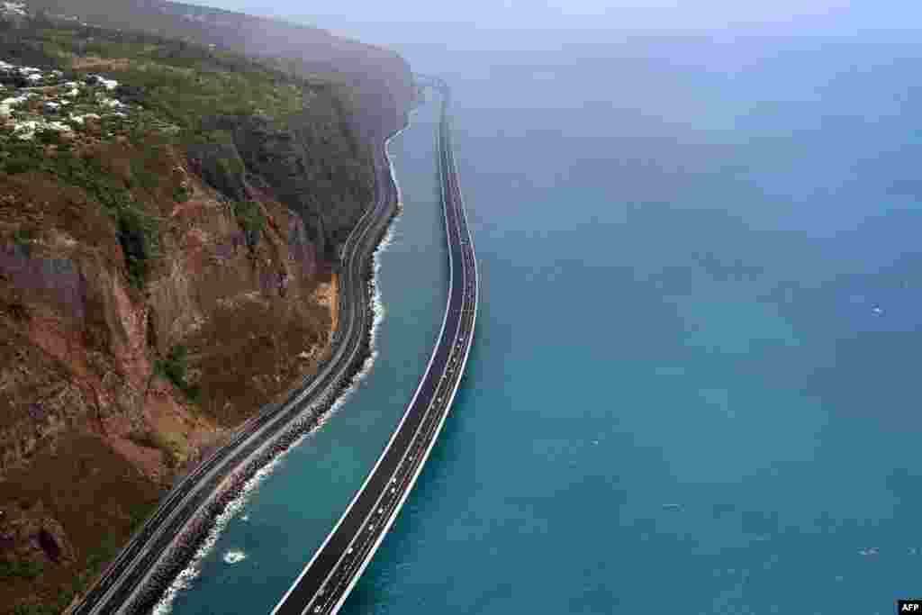 This aerial view shows vehicles travelling on the 'New Coastal Road' 'Nouvelle Route du Littoral (NRL)' near Saint-Denis La Reunion on the French Indian Ocean Island of Reunion, after it was partially opened.
