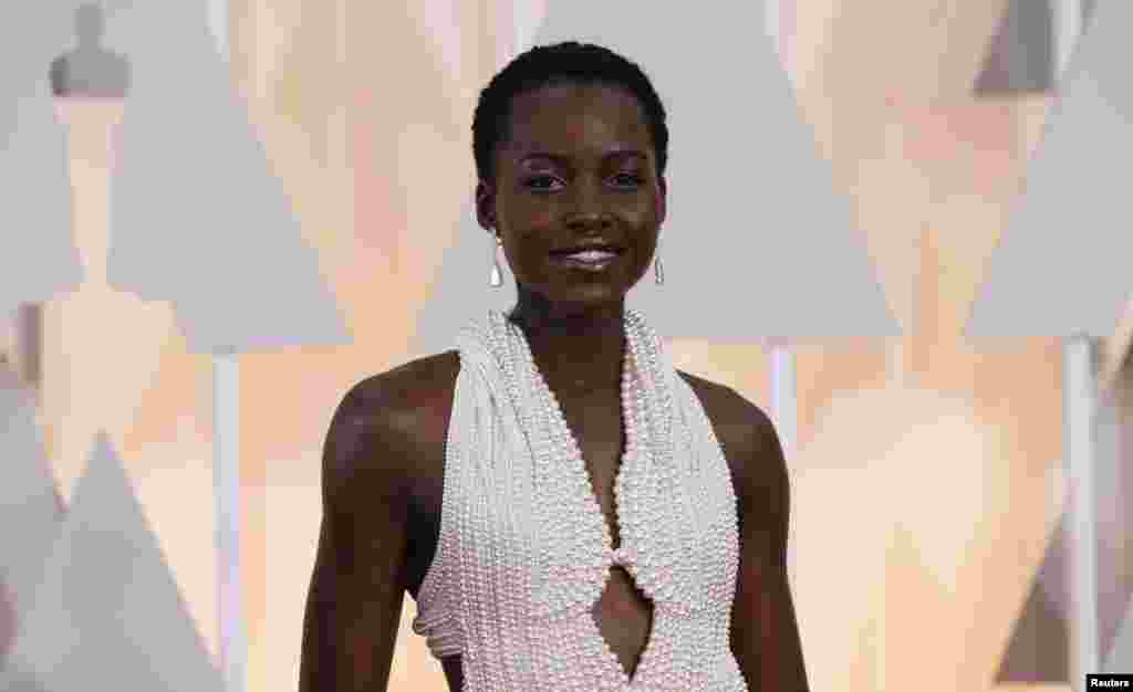 Actress Lupita Nyong'o wears a Calvin Klein gown and Chopard diamonds as she arrives at the 87th Academy Awards in Hollywood, California, Feb. 22, 2015.