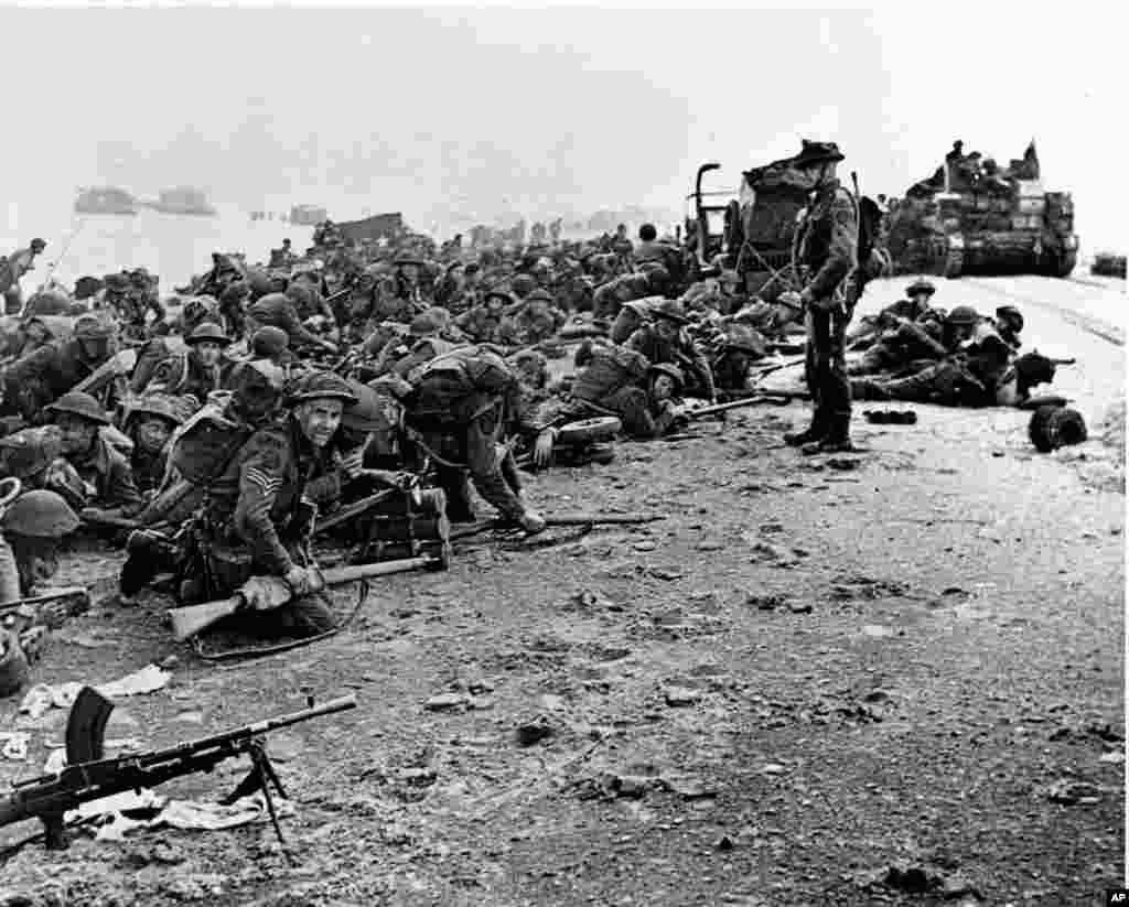 British troops wait for the signal to move forward during the early Allied landing operations in Normandy, France, June 6, 1944. 
