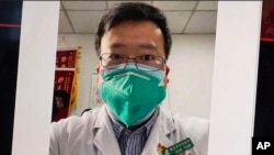 FILE - This image from video shows a selfie of Dr. Li Wenliang, the Chinese doctor who got in trouble with authorities for sounding an early warning about the coronavirus outbreak.