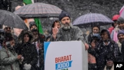 India's opposition Congress party leader Rahul Gandhi, speaks at a public rally as it snows in Srinagar, Indian controlled Kashmir, Monday, Jan. 30, 2023.