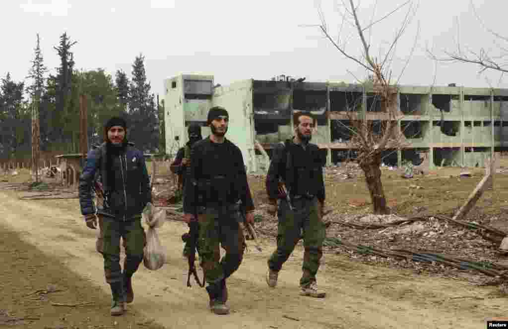 Free Syrian Army fighters walk at the Tameko pharmaceutical factory after the FSA claimed to have taken control of the factory, in eastern al-Ghouta, near Damascus, Jan. 14, 2014.