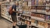A man shops at a supermarket, July 27, 2022, in New York. The US economy shrank from April through June for a second straight quarter, contracting at a 0.9% annual pace and raising fears that the nation may be approaching a recession.