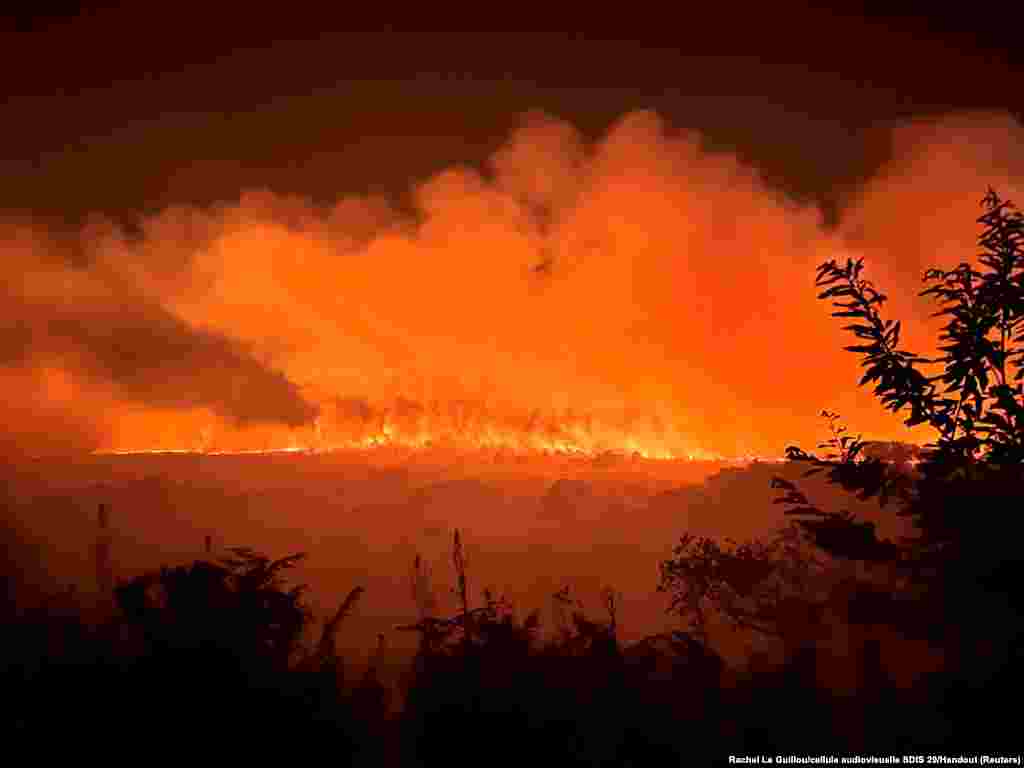 Trees and vegetation burn in a fire that ignited in the Monts d'Arree in Brasparts, in Brittany, France, July 19, 2022.