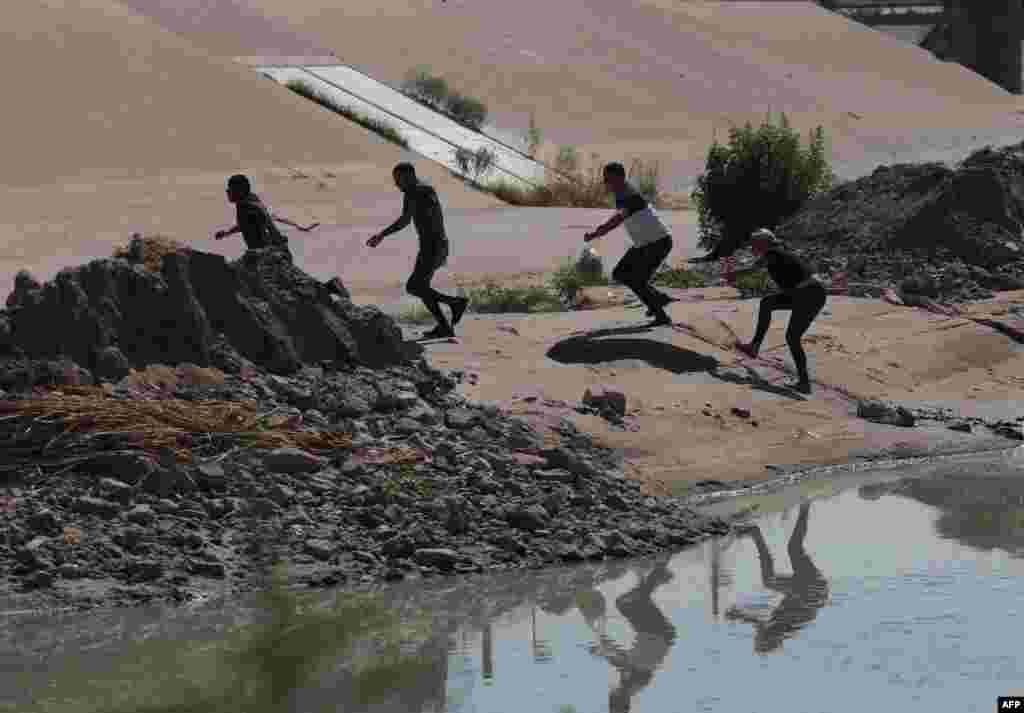 Venezuelan migrants run after crossing the Rio Bravo into the United States to seek for political asylum, as seen from Ciudad Juarez, Chihuahua State, Mexico, Sept. 12, 2022.