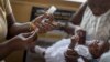 A baby receives Malaria vaccine Mosquirix by a nurse at the maternity ward of the Ewin Polyclinic in Cape Coast, Ghana, April 30, 2019. 