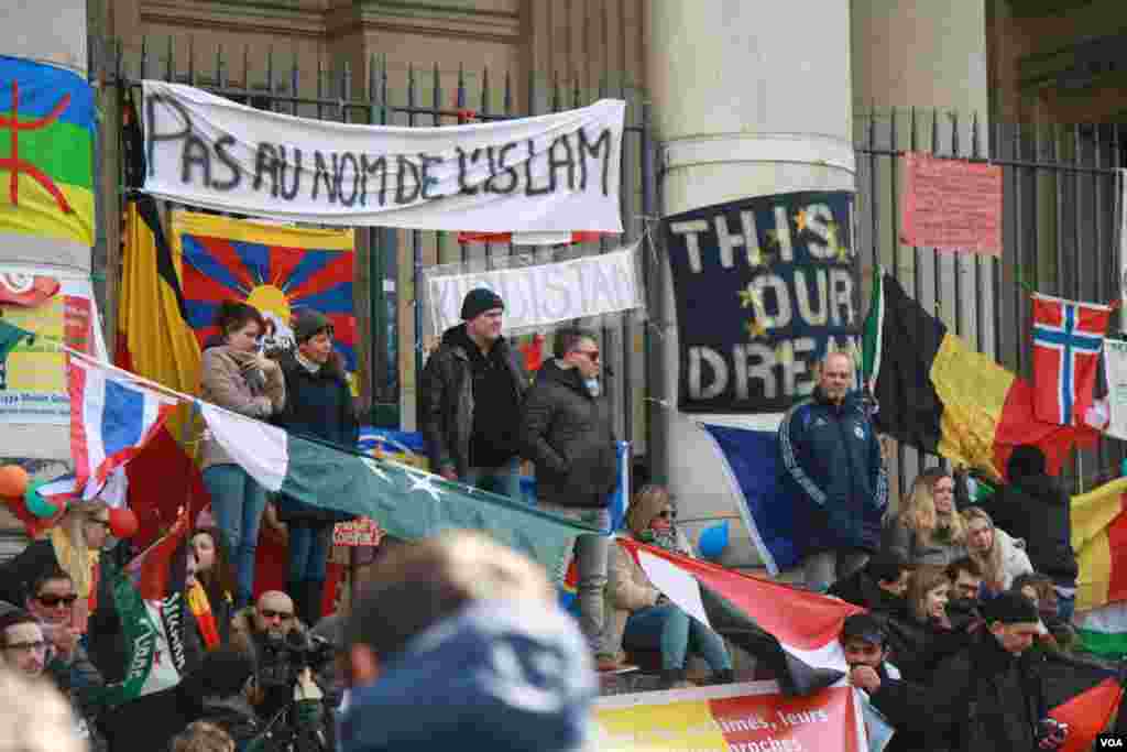 Over the course of the week, the steps of Brussel’s stock exchange building have been decorated with flags from all over the world and messages of solidarity with the victims, including this banner that says “Not in the name of Islam” in French. (H.Murdock/VOA)