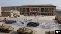 FILE - Chinese People's Liberation Army personnel attend the opening ceremony of China's new military base in Djibouti, Aug. 1, 2017.
