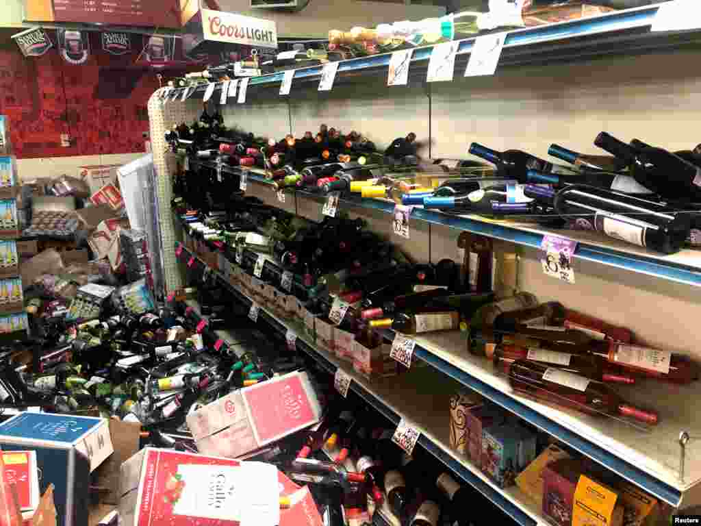 Botellas de vino derribadas se ven en una estantería, después de un terremoto en Eastridge Market. 