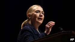 Secretary of State Hillary Rodham Clinton gestures as she gives a speech at Dublin City University in Dublin, Ireland, December 6, 2012.