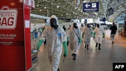 Navy soldiers are seen after carrying out a disinfection operation against the novel coronavirus COVID-19 at Tom Jobim Galeao International Airport in Rio de Janeiro, Brazil, on April 24, 2020.