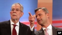 FILE - Norbert Hofer (r) candidate for presidential elections of Austria's Freedom Party, FPOE, talks to Alexander Van der Bellen (l) candidate for presidential elections and former head of the Austrian Greens during the release of the first election results of the Austria presidential elections in Vienna, Austria, April 24, 2016.