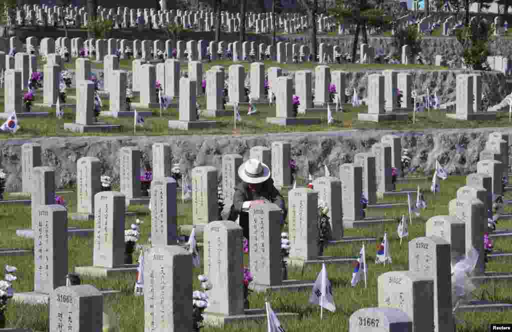 South Korean Jo Kyung-ho pays respect to his brother Jo Chang-ho who died during the 1950-1953 Korean War, on the eve of South Korea's Memorial Day at the National Cemetery in Seoul.