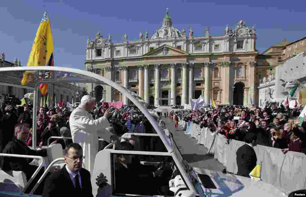 Pope Benedict waves to the faithful after arriving in St. Peter's Square to hold his last general audience at the Vatican, Feb. 27, 2013.