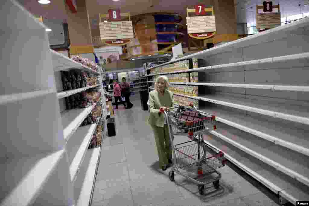 People buy food and other staple goods in a supermarket in Caracas, Venezuela.
