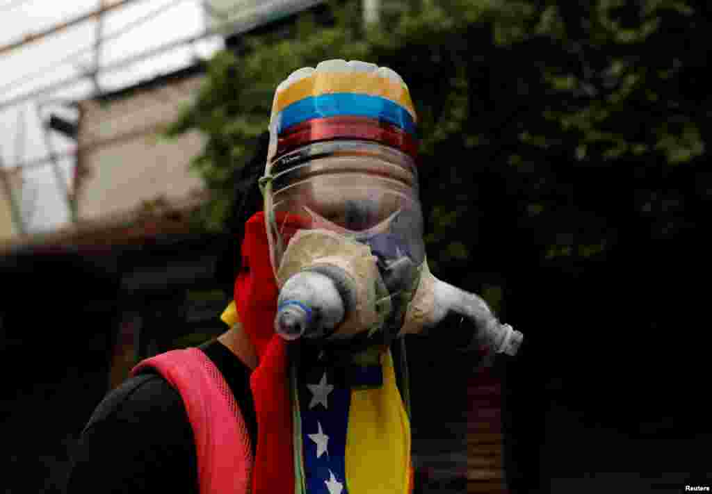 A demonstrator wears a homemade gas mask during a rally against Venezuela's President Nicolas Maduro in Caracas, May 1, 2017.
