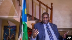 FILE - South Sudan rebel leader Riek Machar talks to reporters at his private residence in Ethiopian capital, Addis Ababa, Feb. 13, 2016
