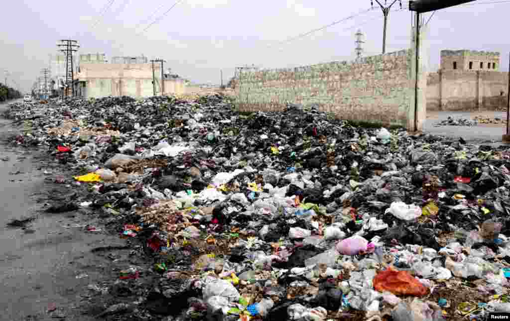 Garbage fills a street in Aleppo, February 11, 2013.