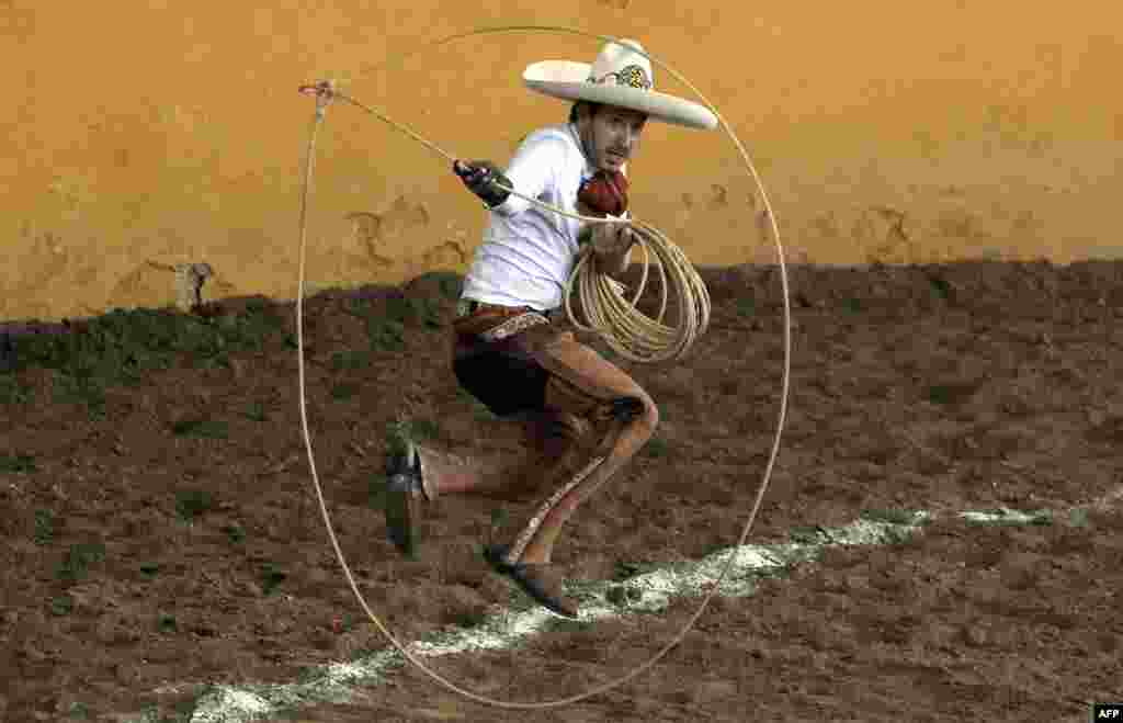 A charro performs the "floreo de reata" during the Charro Day celebrations in Guadalajara, Jalisco state, Mexico, Sept. 14, 2021.