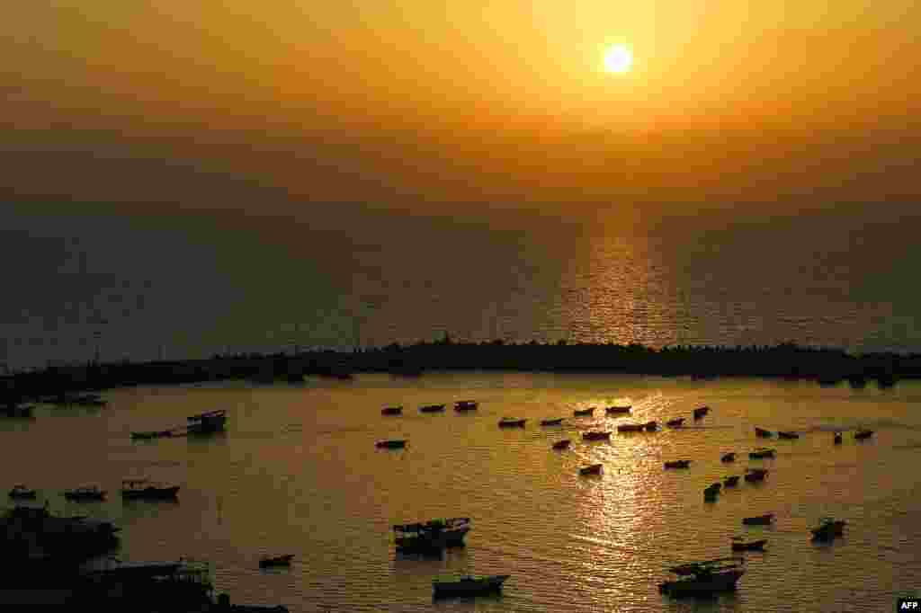 A general view of the boats moored in the seaport of Gaza City is seen at sunset.