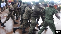 Guinean police arrest a protester on September 28, 2009 in front of the biggest stadium in the capital Conakry during a protest banned by Guinea's former ruling junta.